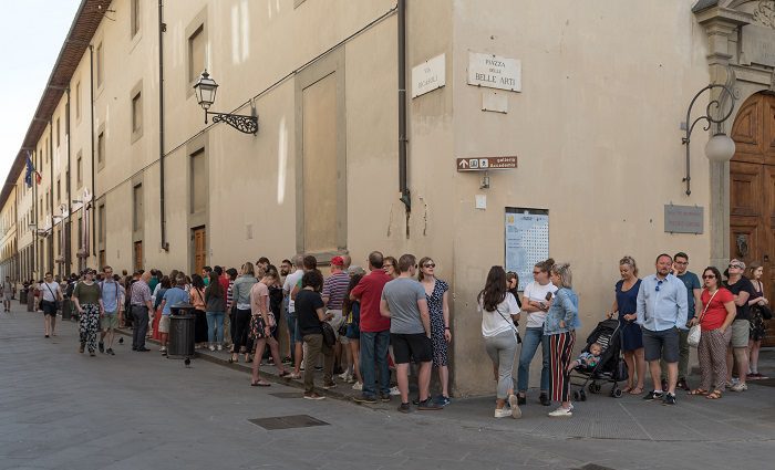 Long line of people waiting to get into the Accademia gallery Florence to see David