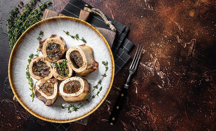 Baked Marrow Beef Bones on Plate With Thyme