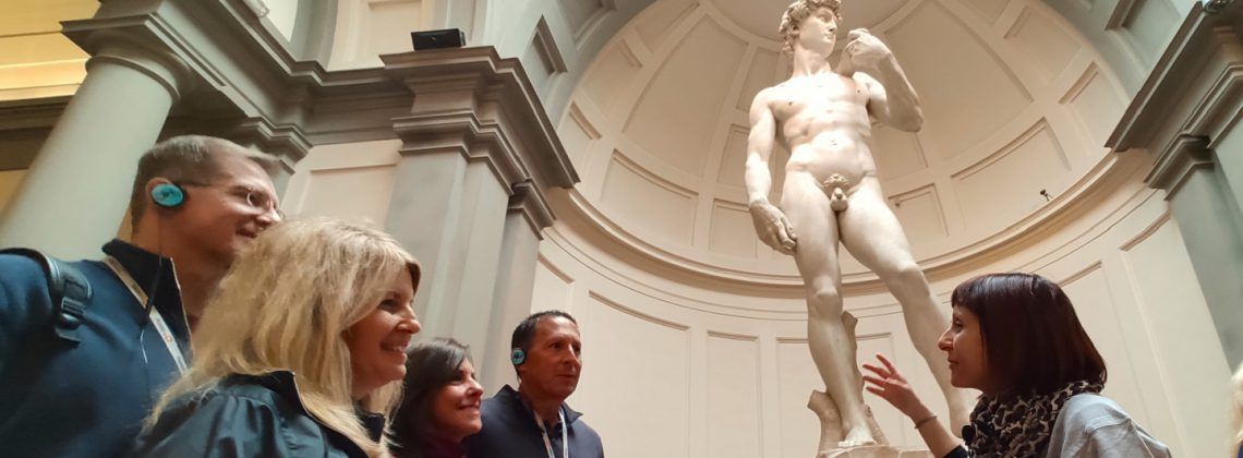 People in front of the Statue of David at the Accademia Gallery in Florence.