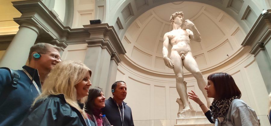 People in front of the Statue of David at the Accademia Gallery in Florence.