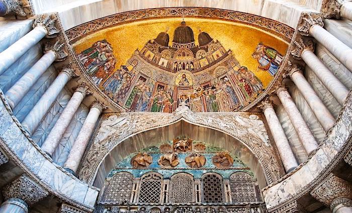 The facade of St Mark's Basilica in Venice with elaborate decoration.
