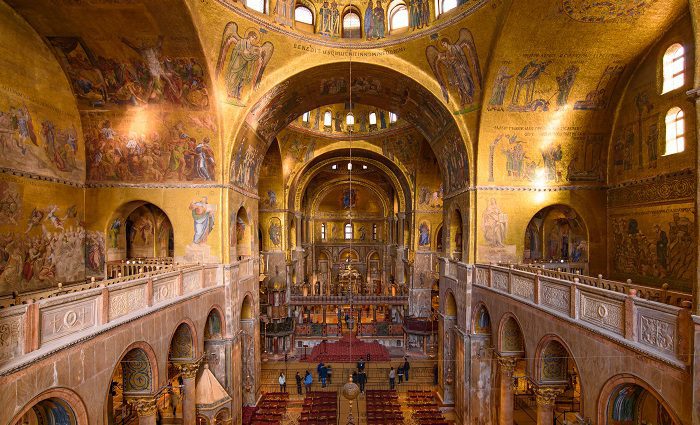 Interior view of St. Mark's Basilica in Vienna with golden mosaics and intricate decorations.