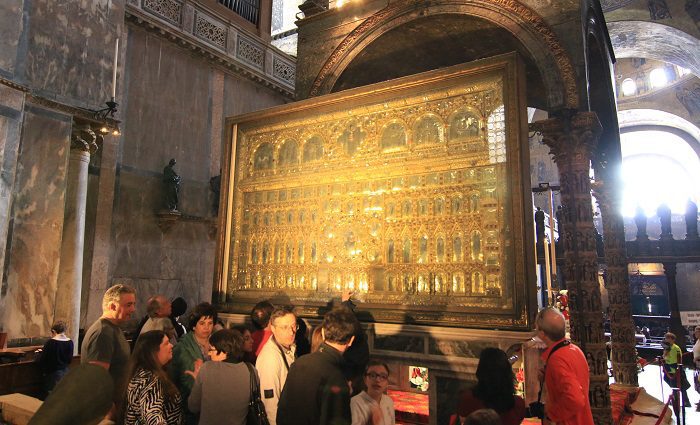 Group of visitors on a St. Mark's Basilica guided tour standing in front of the pala d'oro.