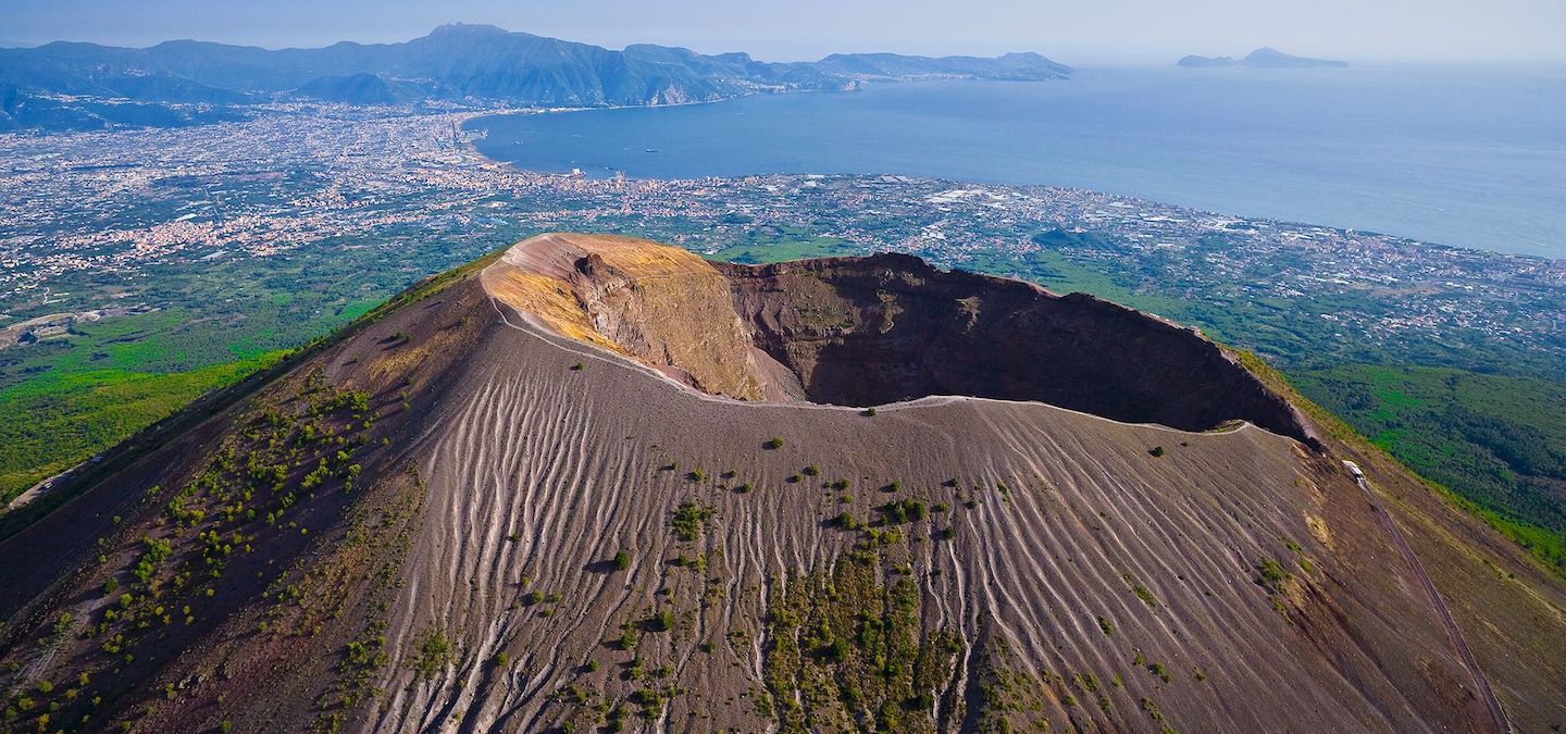  Mount Vesuvius looms over the Bay of Naples, Italy, with the towns of Torre del Greco and Ercolano on the slopes and the island of Capri in the distance.