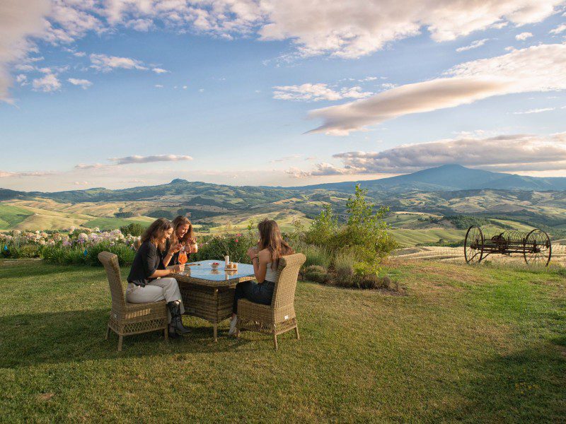 Women overlooking a vineyard at  Podere Val d'Orcia in Tuscany.