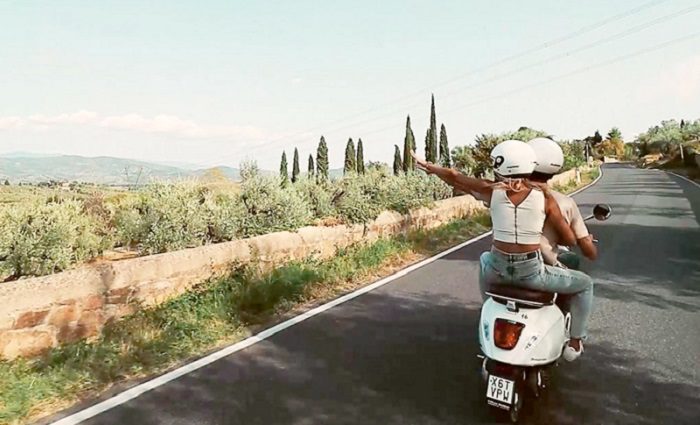 couple on vespa in tuscany