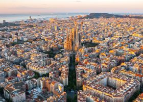 aerial view of barcelona with sagrada familia and sea in the background