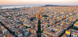 aerial view of barcelona with sagrada familia and sea in the background