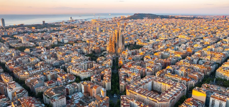 aerial view of barcelona with sagrada familia and sea in the background
