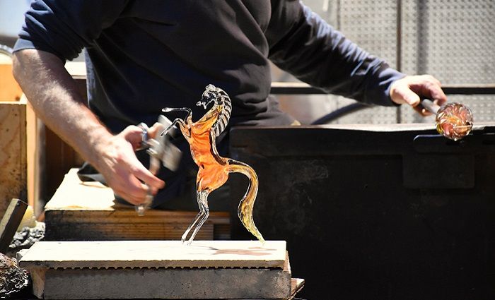 Man shaping a glass blown horse in Murano.