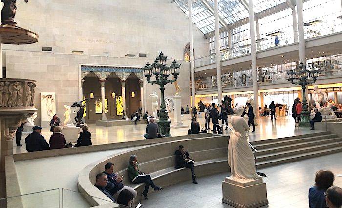 Interior view of the Met Museum in NYC with visitors