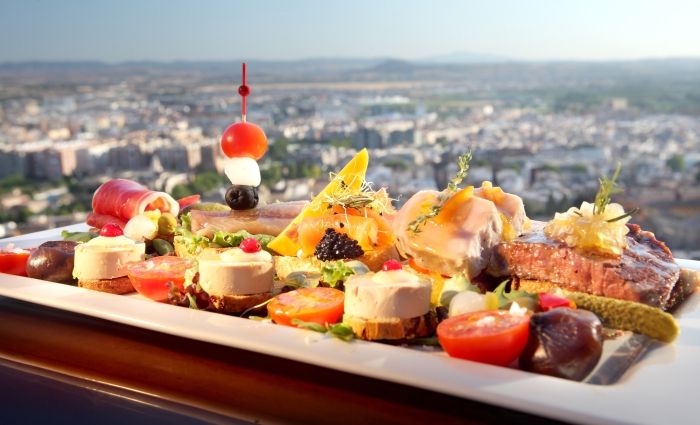 Assorted tapas and panoramic view at restaurant near the Alhambra