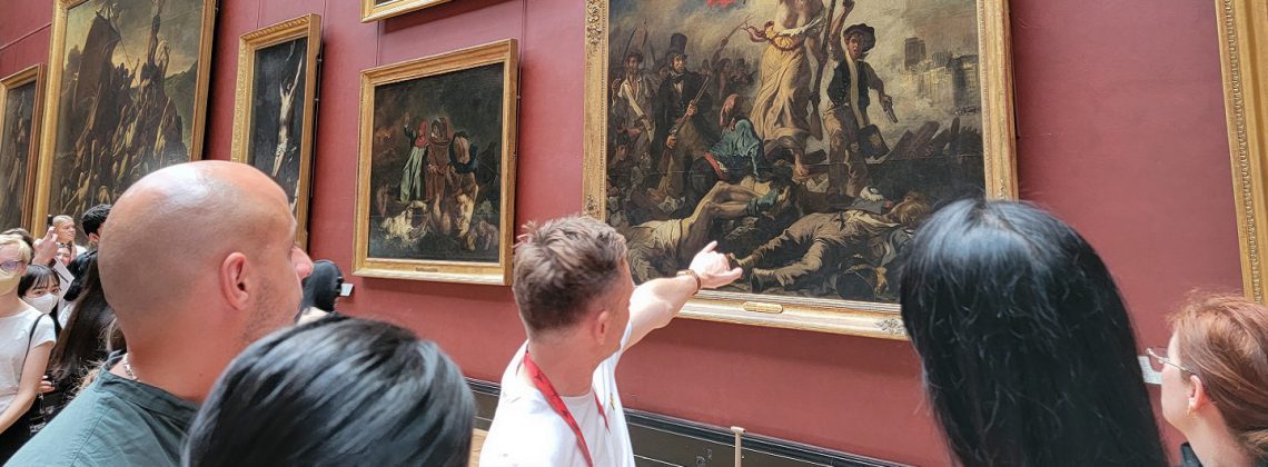 guide pointing at lady leading liberty