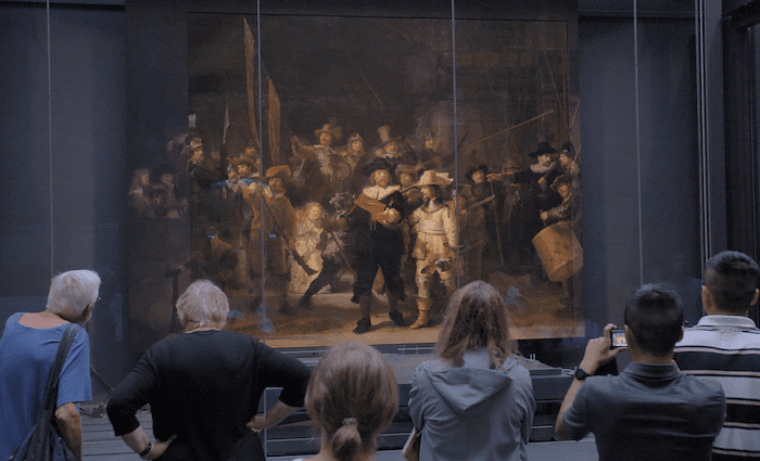 Rijksmuseum visitors in front of The Night Watch painting by Rembrandt