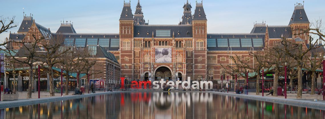 Exterior of Rijksmuseum with I Amsterdam sign in front.