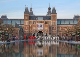 Exterior of Rijksmuseum with I Amsterdam sign in front.