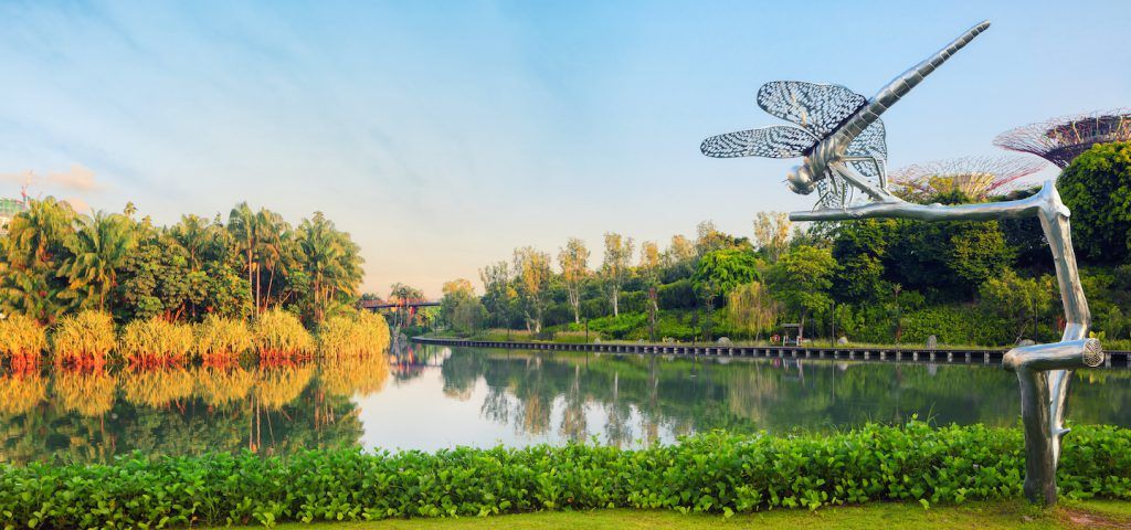Dragonfly statue next to a lake