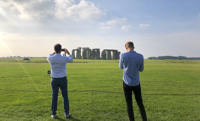 Two tourist take photos as they find Stonehenge worth it