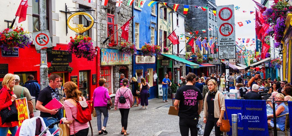 Colorful street of Galway with people walking