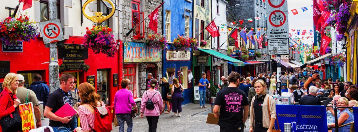 Colorful street of Galway with people walking