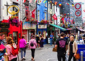 Colorful street of Galway with people walking