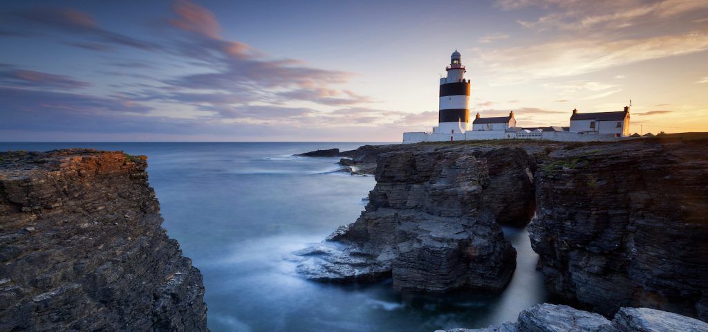 Lighthouse of side of cliff looking over the sea