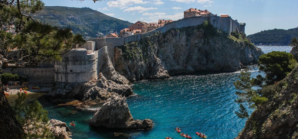 Dubrovnik City Walls with people kayaking below