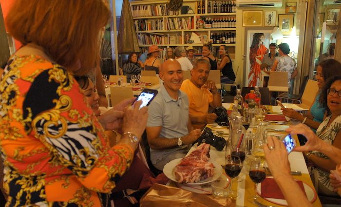 a group enjoy a meal on a food tour.