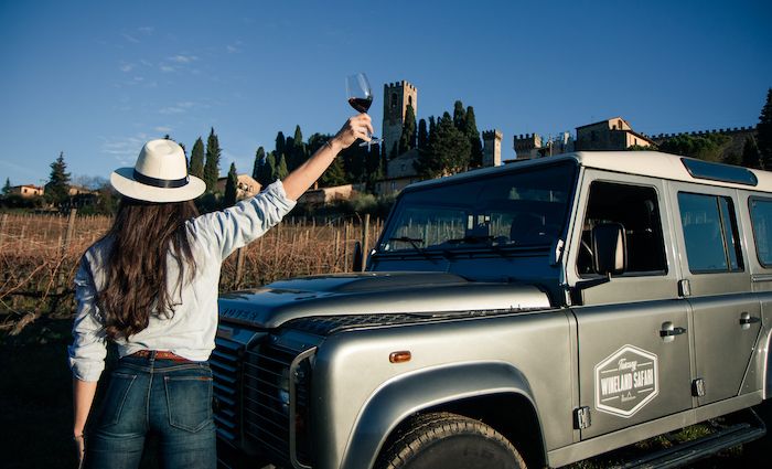 A women enjoys a glass of wine on a wine safari from florence. One of our best Florence tours to take.