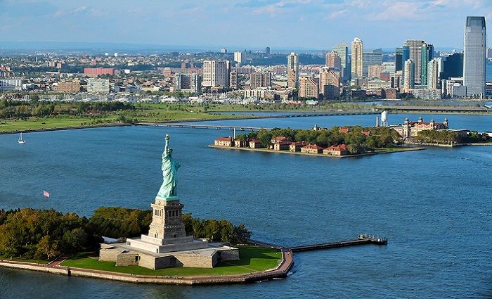 view of Ellis Island and statue of liberty on the Hudson river in NYC