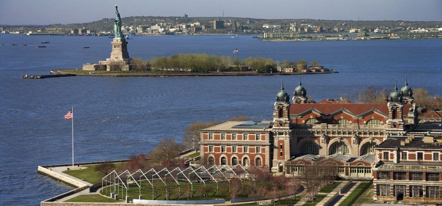 Ellis Island and the statue of liberty in the background.