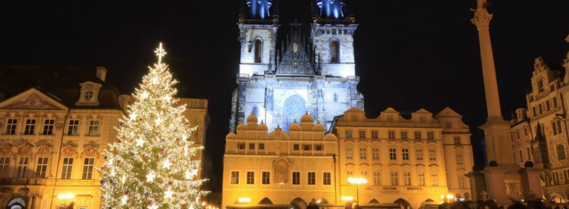 Plaza in Prague with Christmas tree at night.