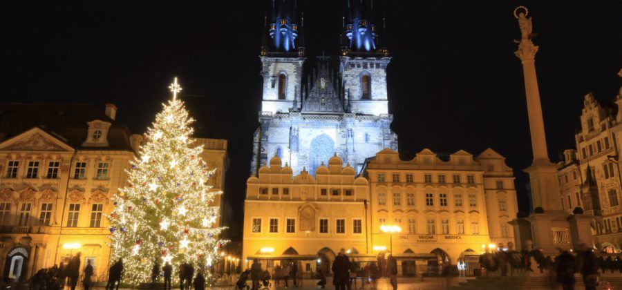 Plaza in Prague with Christmas tree at night.