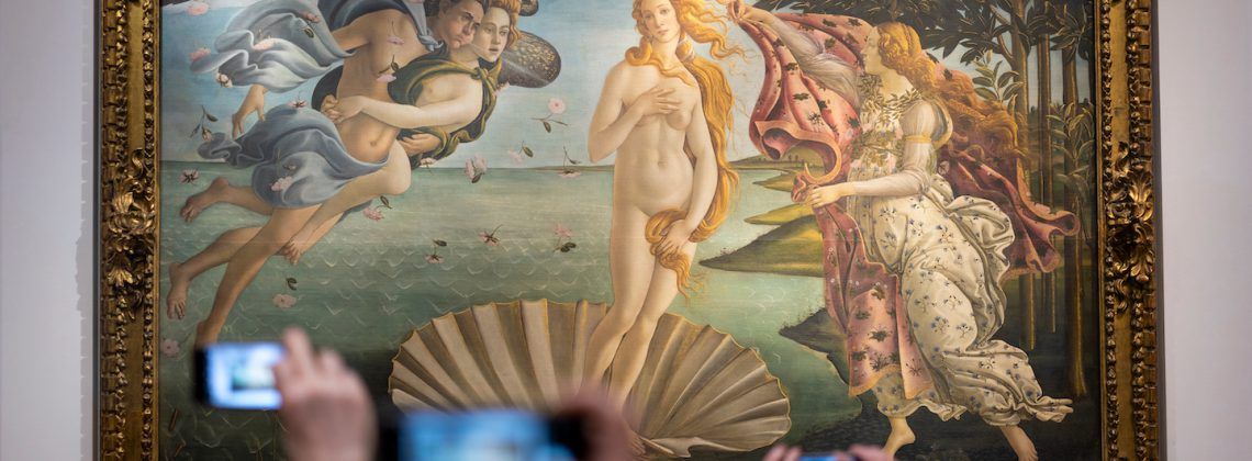 People taking photos of artwork.