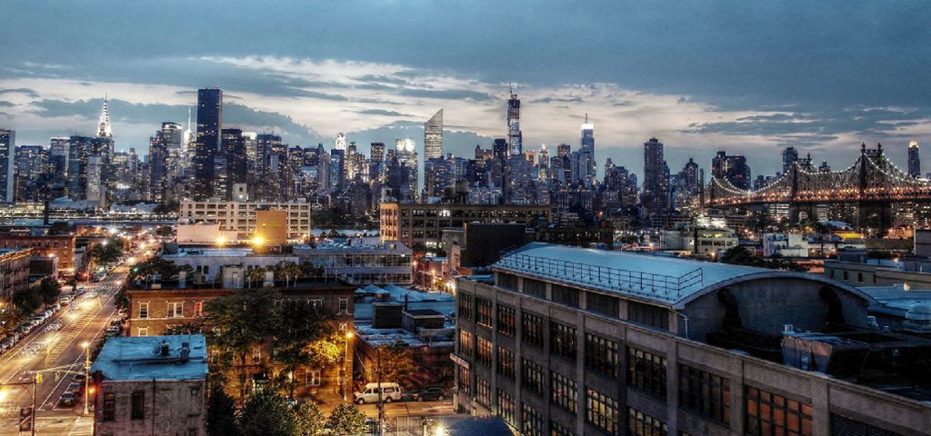Queens Borough with NYC Skyline at night.