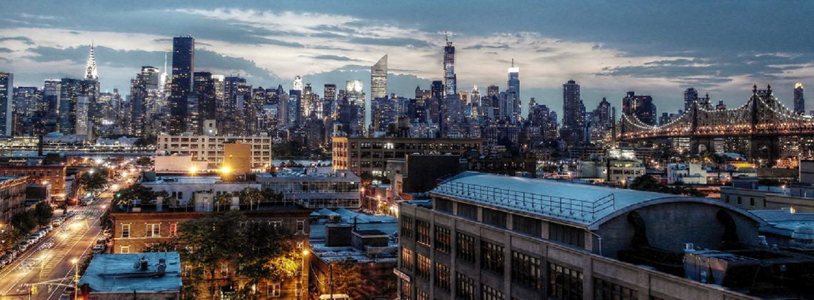 Queens Borough with NYC Skyline at night.