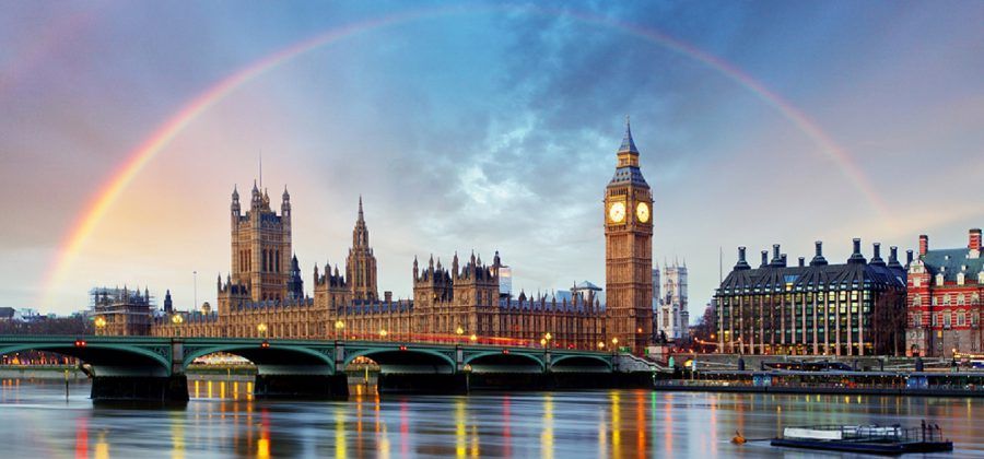 The big Ben and the Houses of Parliament under a rainbow.