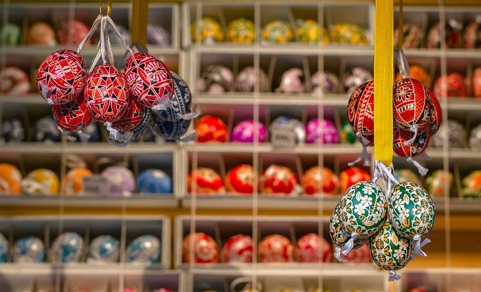 Colourful painted easter eggs hanging in a stall at Prague's traditional Easter market