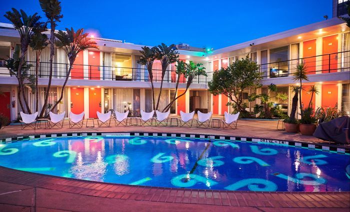 Outdoor pool with Phoenix hotel in the background at night.