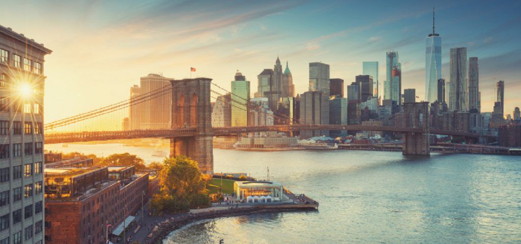 NYC skyline with Brooklyn bridge during the sunset.
