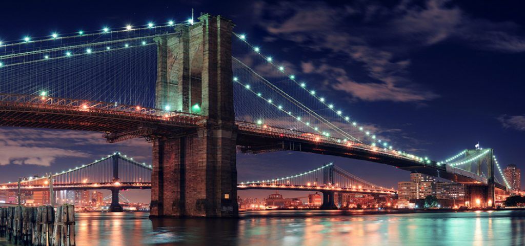 Brooklyn Bridge lit up at night.