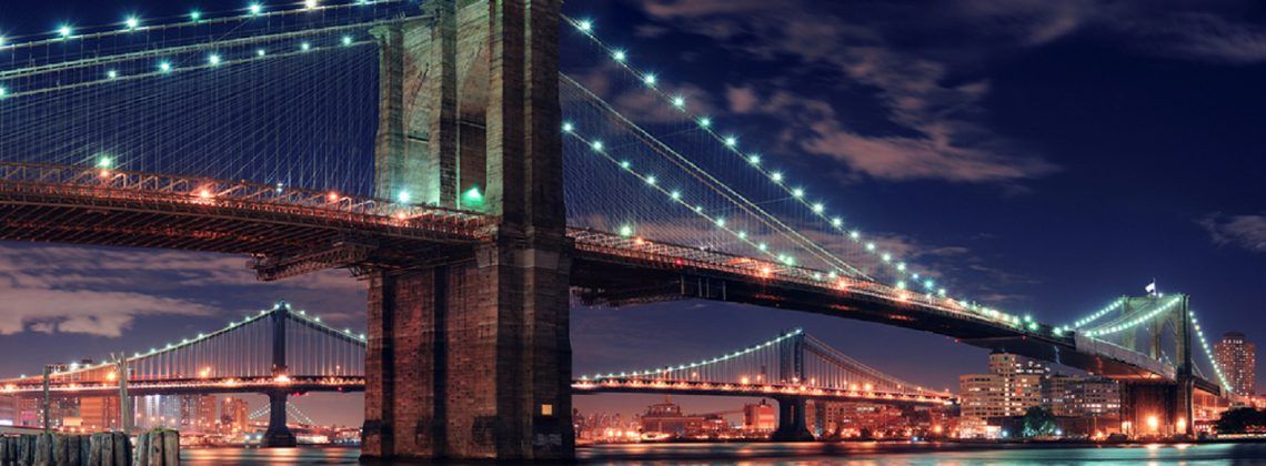 Brooklyn Bridge lit up at night.