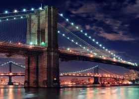 Brooklyn Bridge lit up at night.