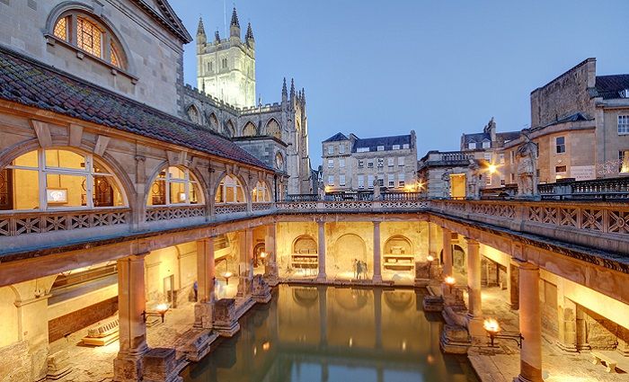 Interior courtyard of Old Roman baths in England at night.