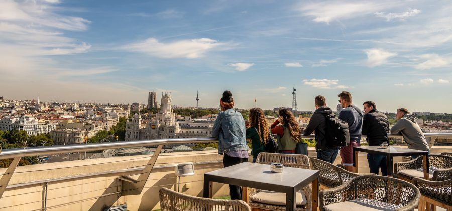 Group of people looking out to the skyline of Madrid.