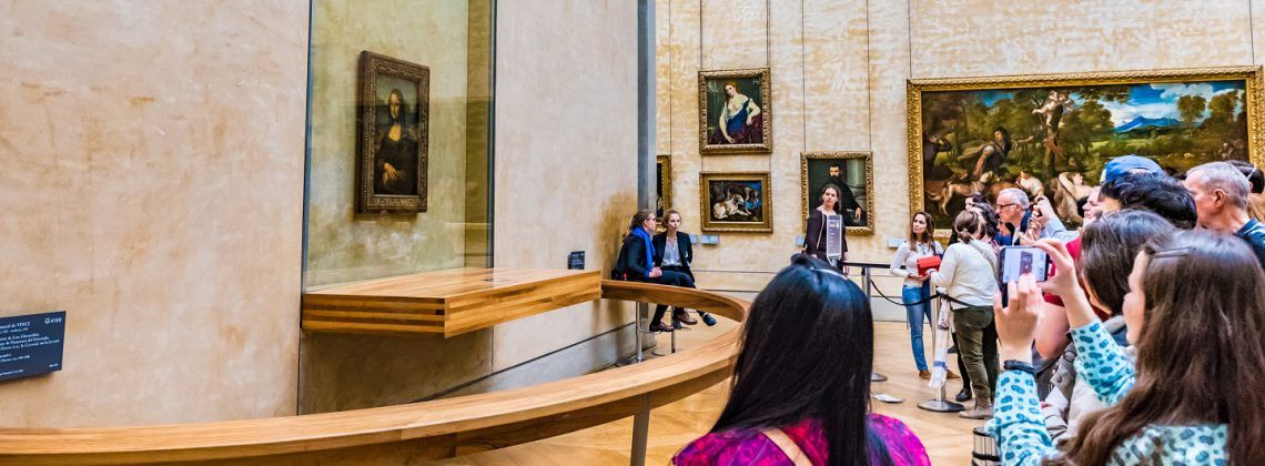 Group of people taking photos of Mona Lisa.