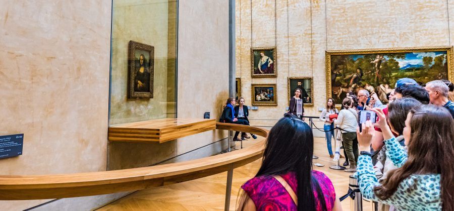 Group of people taking photos of Mona Lisa.