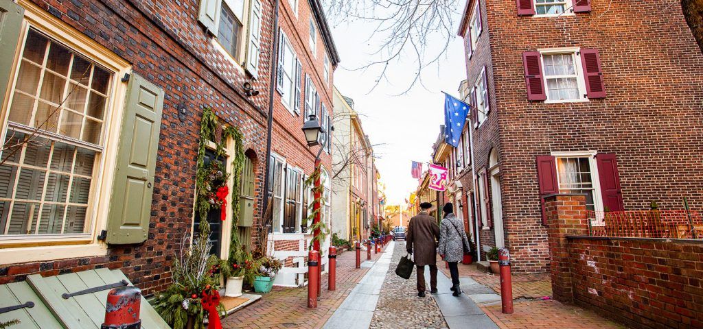 Two people walking through Elfreth's alley.