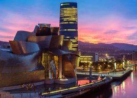 Exterior of the Guggenheim Museum in Bilbao at sunset.