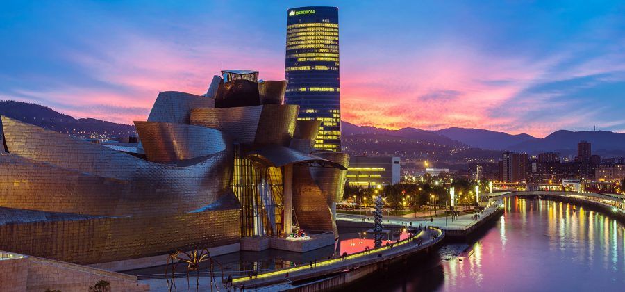 Exterior of the Guggenheim Museum in Bilbao at sunset.